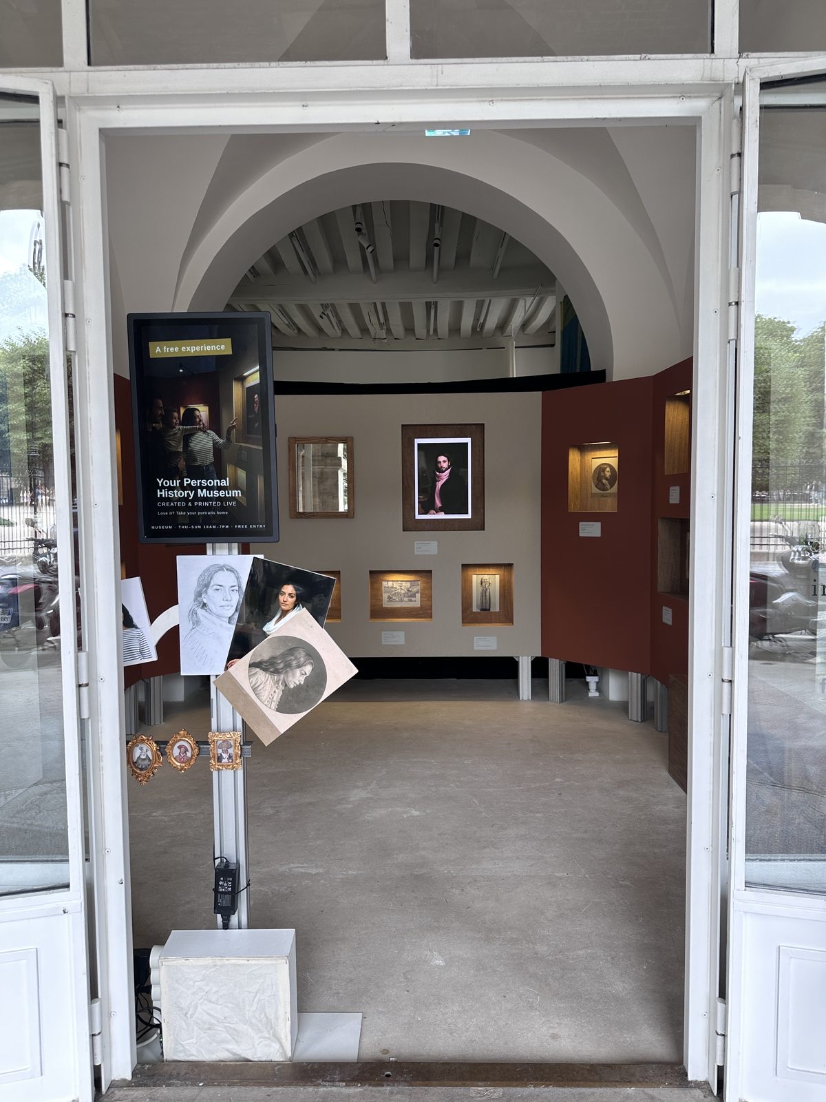 The doorway of the shop, opening onto the hung portraits